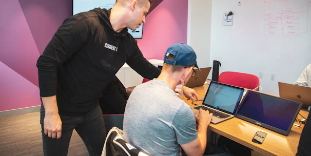A focused engineering team collaborating over technical blueprints in a modern workspace.